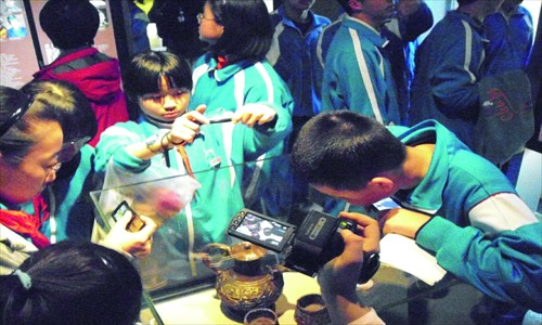 Children inspect stage props that have been well-preserved
