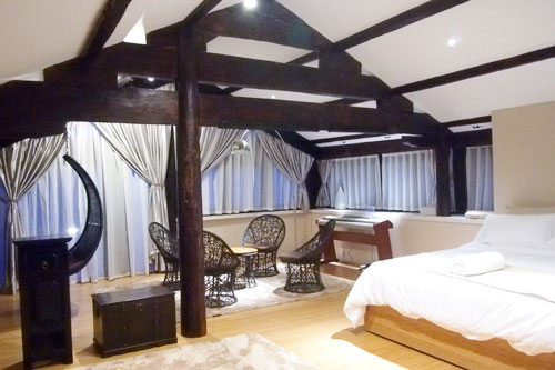 Old wood, polished by age, can be seen in the master bedroom of the family villa at the Bivou. Teo Siok Kuan / For China Daily
