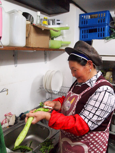 Spring Ayi at work in the kitchen. Bivou bistro offers organic dishes, and Bob, a visiting scholar from Australia, manages the coffee bar and the barbecue.