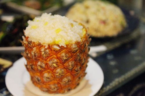 Glutinous rice mixed with pineapple chunks.[Photo by Fan Zhen/China Daily]