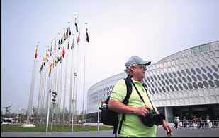 A foreign tourist walks outside the main exhibition hall of the expo. 