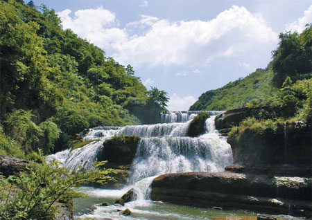 A roaring waterfall cascades down the mountain like a ribbon along the Taoyuan River. Provided to China Daily  