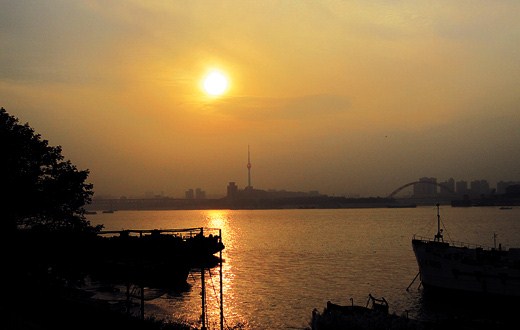 Early morning on Donghu Lake is not to be missed. The mirror-like lake reflects vivid autumn colors of nearby trees.