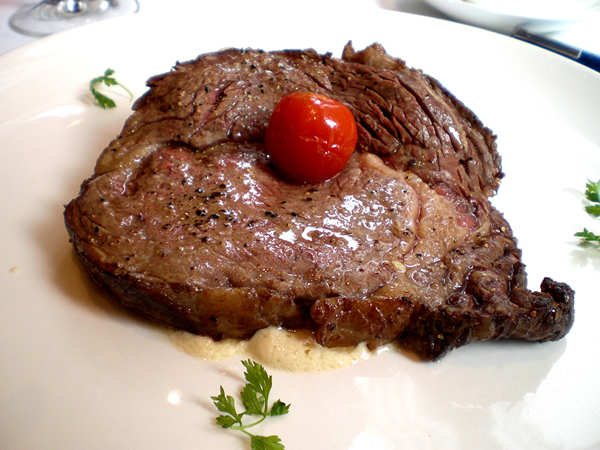 Roasted Rib Eye of Beef with Creamy Blue Cheese Sauce. [Photo: China Daily] 