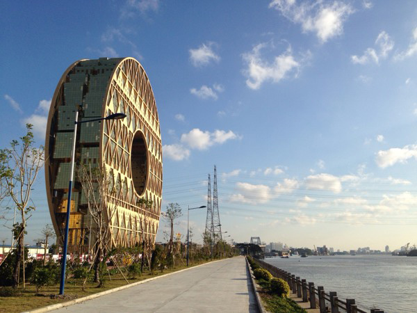The newly constructed Guangzhou Circle, home to the Guangdong Plastic Exchange. The 138-meter-tall building resembles an ancient Chinese coin, or a bi (a jade disc which symbolized the elite, and the heavens). The building rests on the edge of the Pearl River, and with its reflection below, the building takes the form of the number eight -- and eights, of course, are considered to represent good fortune in China.