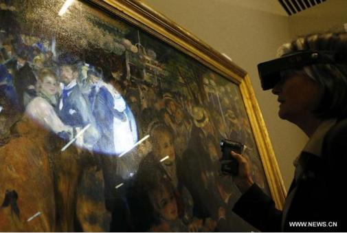 A French expert checks Auguste Renoir's masterpiece Dance at Le Moulin de la Galette at the National Museum of China in Beijing, capital of China, April 8, 2014. (Photo source: Xinhuanet)