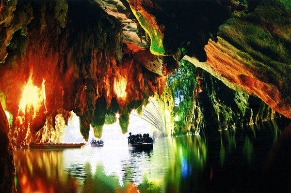 Visitors take a boat trip through the Dragon Palace, a natural karst cave with stalactites. Photo Provided to China Daily
