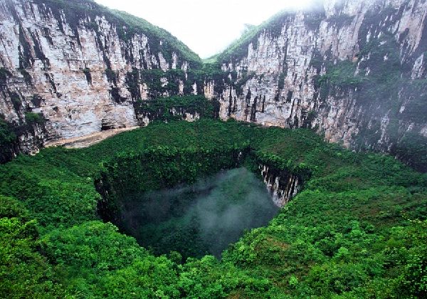 The 600-meter-deep sinkhole in Fengjie county, Chongqing, is coated with green vegetation in spring. Zhang Sanyou / China Daily