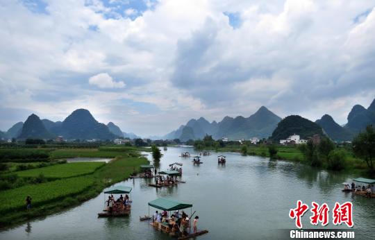 The photo taken in 2012 shows tourists are boating at the Yulong River in Yangshuo county, Guangxi province. [Photo/chinanews.com]