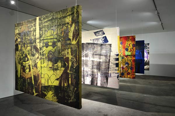 Shezad Dawood's Through Pierced Flesh and Skin of Dreams is an installation of five paintings on suspended textiles. [Photo/China Daily]  