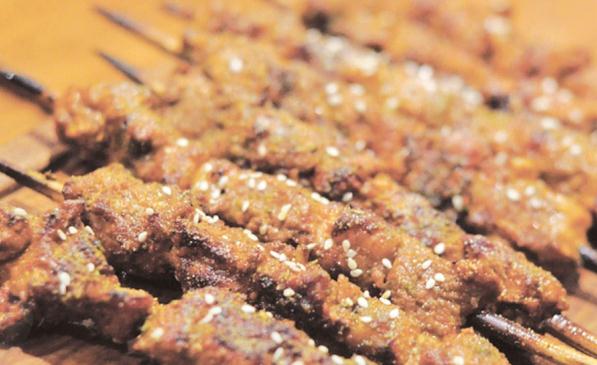 Lamb skewers, with sesame and cumin seeds on top, are popular dishes from Miss Ali.
