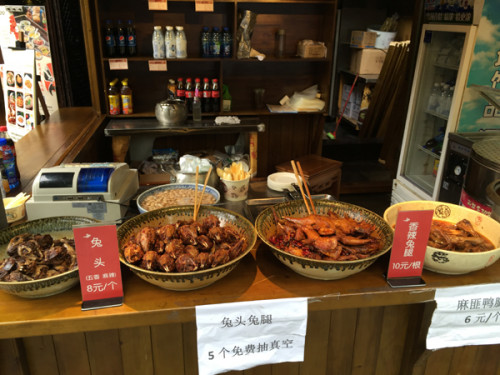 Chengdu, the ancient gateway to the southern Silk Road, has long been a magnet for visitors who love food. Rabbit head at Jinli Old Street. (Photo: Mike Peters/China Daily)