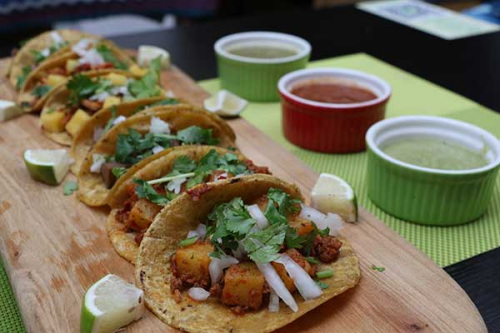 Signature dishes offered by Pebbles Courtyard include chips and dips (top) and 'streetstyle' tacos (above).Photo By Hannah Adamson/For China Daily