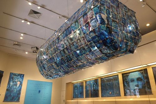 Slave Boat, woven with 500 real photos of African-American slaves, is on display at US multimedia artist Toni Scott's solo show in Beijing.(Photo by Xu Bocheng/For China Daily)