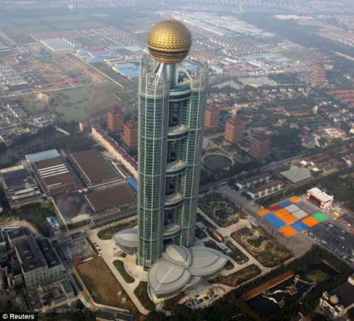 The newly-opened skyscraper in Huaxi Village, Jiangsu province, dwarfs the surrounding buildings.