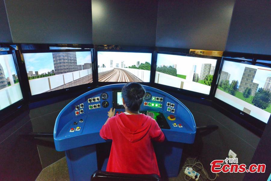 A girl “drives” a subway train in a driving simulation room featured in China’s first metro museum that opened in Shanghai on Tuesday, October 28, 2014. [Photo: China News Service/ Yuan Jing]