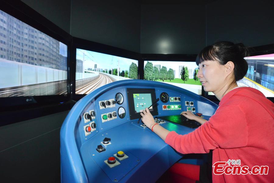 A girl “drives” a subway train in a driving simulation room featured in China’s first metro museum that opened in Shanghai on Tuesday, October 28, 2014. [Photo: China News Service/ Yuan Jing]