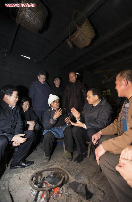 Chinese Premier Li Keqiang, also a member of the Standing Committee of the Political Bureau of the Communist Party of China (CPC) Central Committee, visits the family of Lin Xianping, a villager in Pudong Village of Liping County, Qiandongnan Miao and Dong Autonomous Perfecture of southwest China\'s Guizhou Province, Feb. 13, 2015. Li made a tour in Qiandongnan Miao and Dong Autonomous Perfecture and Guiyang in Guizhou on Feb. 13 - 15, and extended festival greetings to locals and people of all ethnic groups ahead of the Spring Festival, which falls on Feb. 19. (Photo: Xinhua/Huang Jingwen)