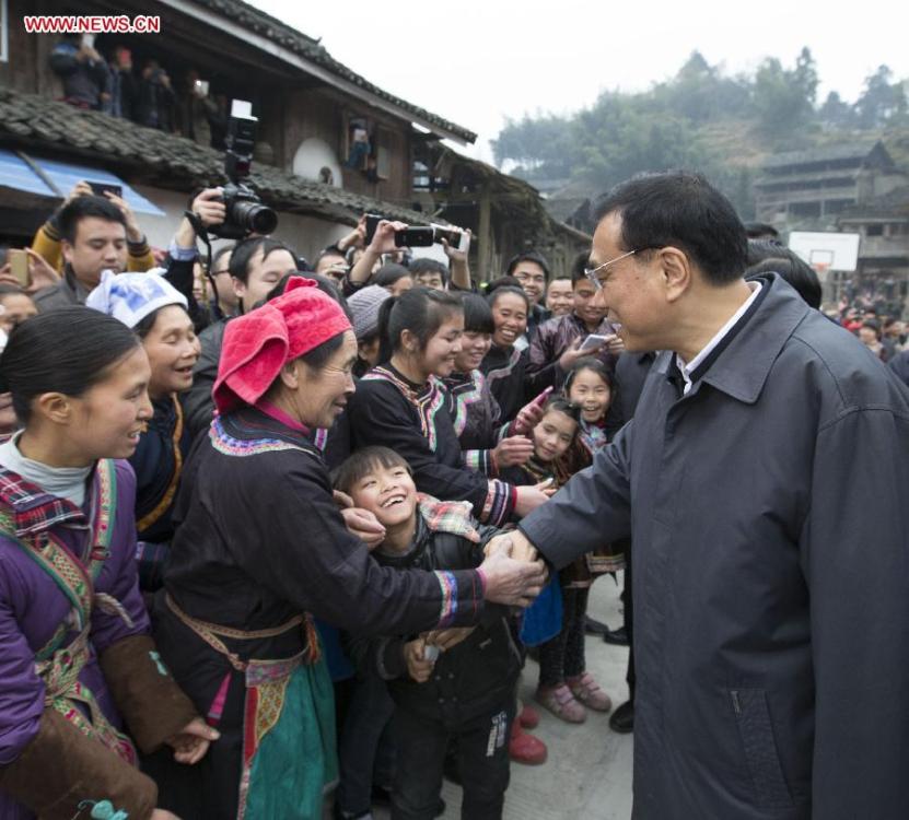 Chinese Premier Li Keqiang, also a member of the Standing Committee of the Political Bureau of the Communist Party of China (CPC) Central Committee, visits local villagers in Pudong Village of Liping County, Qiandongnan Miao and Dong Autonomous Perfecture of southwest China\'s Guizhou Province, Feb. 13, 2015. Li made a tour in Qiandongnan Miao and Dong Autonomous Perfecture and Guiyang in Guizhou on Feb. 13 - 15, and extended festival greetings to locals and people of all ethnic groups ahead of the Spring Festival, which falls on Feb. 19. (Photo: Xinhua/Huang Jingwen)