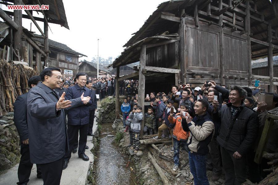 Chinese Premier Li Keqiang, also a member of the Standing Committee of the Political Bureau of the Communist Party of China (CPC) Central Committee, visits local villagers in Pudong Village of Liping County, Qiandongnan Miao and Dong Autonomous Perfecture of southwest China\'s Guizhou Province, Feb. 13, 2015. Li made a tour in Qiandongnan Miao and Dong Autonomous Perfecture and Guiyang in Guizhou on Feb. 13 - 15, and extended festival greetings to locals and people of all ethnic groups ahead of the Spring Festival, which falls on Feb. 19. (Photo: Xinhua/Huang Jingwen)
