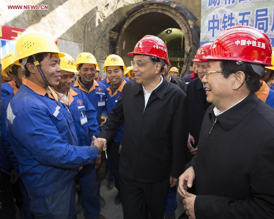 Chinese Premier Li Keqiang, also a member of the Standing Committee of the Political Bureau of the Communist Party of China (CPC) Central Committee, visits workers at a construction site of Guiyang Metro system in Guiyang, capital of southwest China\'s Guizhou Province, Feb. 14, 2015. Li made a tour in Qiandongnan Miao and Dong Autonomous Perfecture and Guiyang in Guizhou on Feb. 13 - 15, and extended festival greetings to locals and people of all ethnic groups ahead of the Spring Festival, which falls on Feb. 19. (Photo: Xinhua/Huang Jingwen)