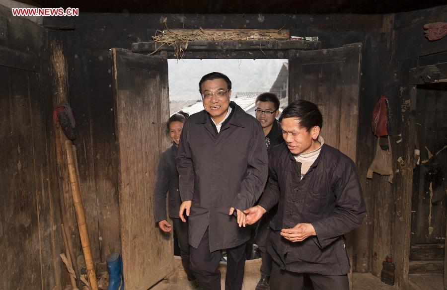 Chinese Premier Li Keqiang, also a member of the Standing Committee of the Political Bureau of the Communist Party of China (CPC) Central Committee, visits the family of Wu Longqian, a local villager in Pudong Village of Liping County, Qiandongnan Miao and Dong Autonomous Perfecture of southwest China\'s Guizhou Province, Feb. 13, 2015. Li made a tour in Qiandongnan Miao and Dong Autonomous Perfecture and Guiyang in Guizhou on Feb. 13 - 15, and extended festival greetings to locals and people of all ethnic groups ahead of the Spring Festival, which falls on Feb. 19. (Photo: Xinhua/Huang Jingwen)