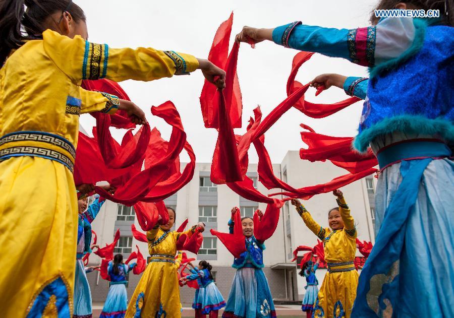 Pupils practice traditional Andai Dance in N China