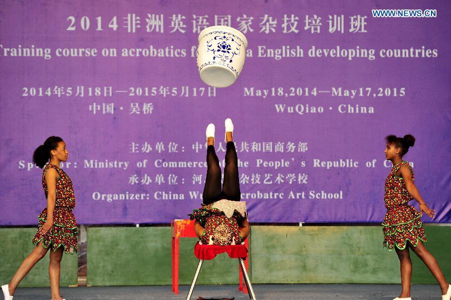 African students perform acrobatics on the commencement of their course in Cangzhou, north China\'s Hebei Province, May 13, 2015. Twenty-six students from English-speaking African countries took the one-year acrobatic course in Wuqiao International Acrobatic Art School and acquired skills of about 20 acrobatic shows. Wuqiao county, also known as \