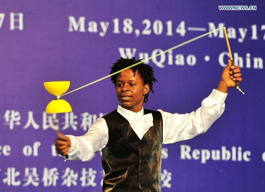 An African student performs acrobatics on the commencement of their course in Cangzhou, north China\'s Hebei Province, May 13, 2015. Twenty-six students from English-speaking African countries took the one-year acrobatic course in Wuqiao International Acrobatic Art School and acquired skills of about 20 acrobatic shows. Wuqiao county, also known as \