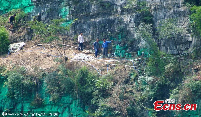 Villager paints cliff wall green for good luck(1/3)