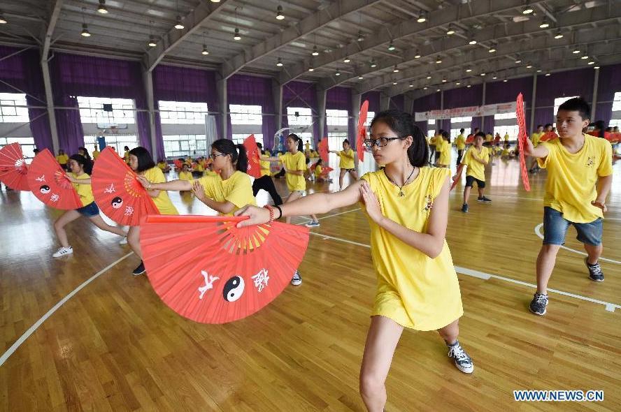 Overseas Chinese youth learn to perform Kung Fu Fan during the \