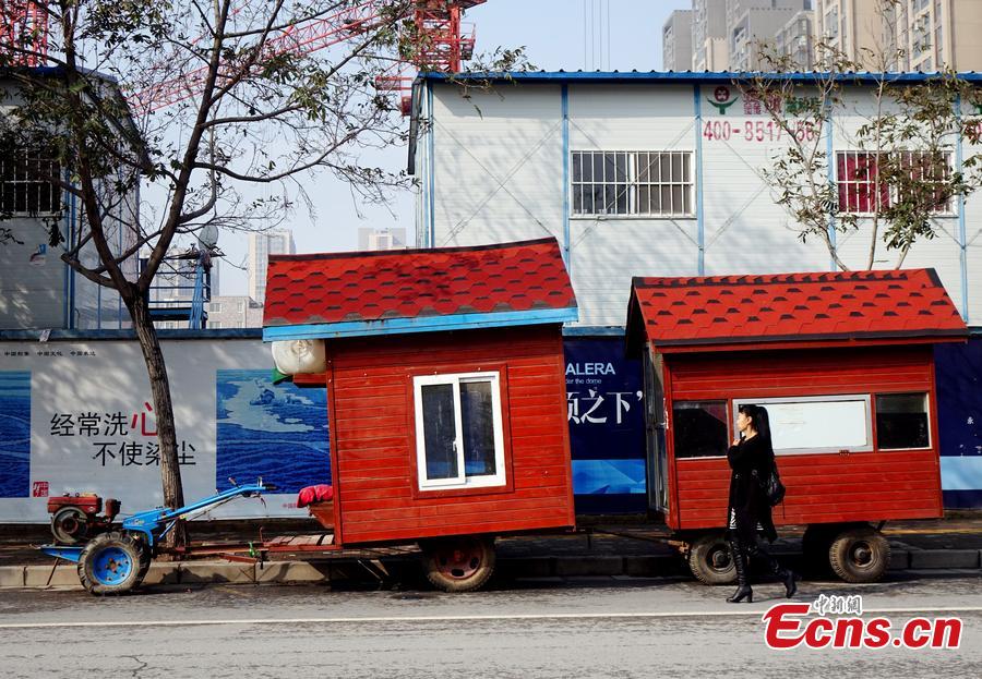 A “motorhome” converted from a tractor is seen on a street in Zhengzhou, Central China’s Henan province on October 26, 2015. The vehicle features two rooms with red walls and roofs was transformed by a local farmer.  (Photo/CFP)