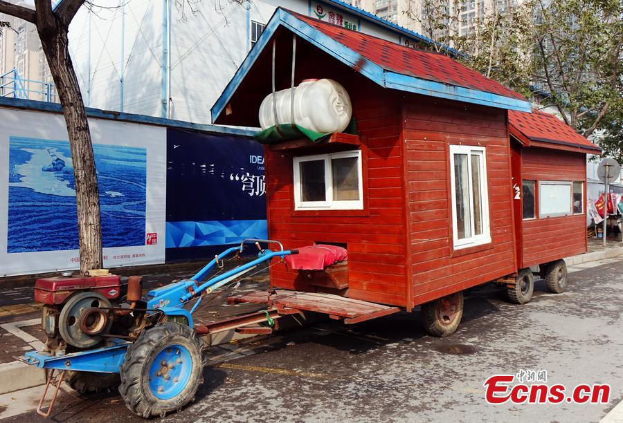 A “motorhome” converted from a tractor is seen on a street in Zhengzhou, Central China’s Henan province on October 26, 2015. The vehicle features two rooms with red walls and roofs was transformed by a local farmer.  (Photo/CFP)