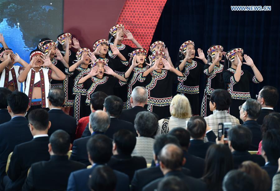 Members of a children chorus sing at the opening ceremony of the Southern Branch of Palace Museum in Chiayi, southeast China\'s Taiwan, Dec. 28, 2015. A long-awaited new branch of Taipei\'s Palace Museum was inaugurated in Chiayi city of south Taiwan on Monday. The project, with an area of about 68 hectares, is made up of a museum building, a green park and a lake. It costs more than 10.93 billion New Taiwan dollars (341 million U.S. dollars) and the design and construction took about 11 years. (Photo: Xinhua/Jiang Kehong)