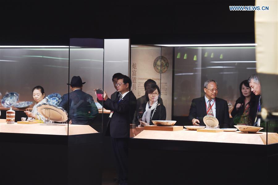 Visitors look at the porcelain works at the Southern Branch of Palace Museum in Chiayi, southeast China\'s Taiwan, Dec. 28, 2015. A long-awaited new branch of Taipei\'s Palace Museum was inaugurated in Chiayi city of south Taiwan on Monday. The project, with an area of about 68 hectares, is made up of a museum building, a green park and a lake. It costs more than 10.93 billion New Taiwan dollars (341 million U.S. dollars) and the design and construction took about 11 years. (Photo: Xinhua/Jiang Kehong)