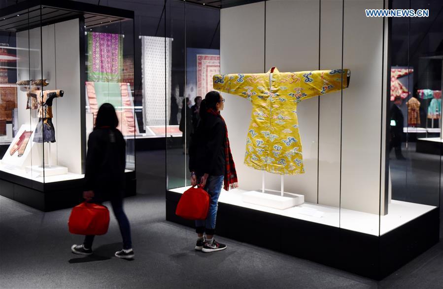 Visitors attend an Asian textile exhibition at the Southern Branch of Palace Museum in Chiayi, southeast China\'s Taiwan, Dec. 28, 2015. A long-awaited new branch of Taipei\'s Palace Museum was inaugurated in Chiayi city of south Taiwan on Monday. The project, with an area of about 68 hectares, is made up of a museum building, a green park and a lake. It costs more than 10.93 billion New Taiwan dollars (341 million U.S. dollars) and the design and construction took about 11 years. (Photo: Xinhua/Jiang Kehong)
