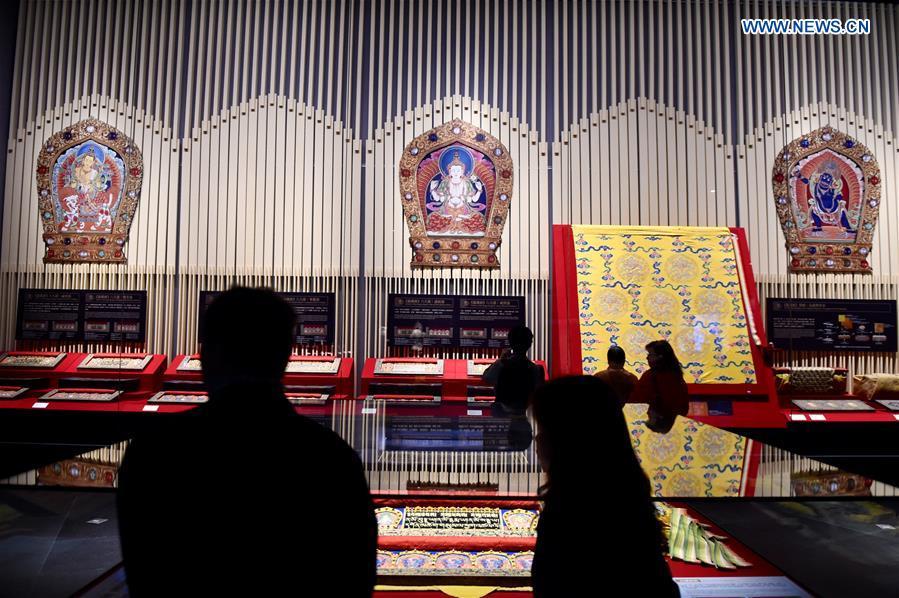 Visitors attend an exhibition on Asian Buddhist artworks at the Southern Branch of Palace Museum in Chiayi, southeast China\'s Taiwan, Dec. 28, 2015. A long-awaited new branch of Taipei\'s Palace Museum was inaugurated in Chiayi city of south Taiwan on Monday. The project, with an area of about 68 hectares, is made up of a museum building, a green park and a lake. It costs more than 10.93 billion New Taiwan dollars (341 million U.S. dollars) and the design and construction took about 11 years. (Photo: Xinhua/Jiang Kehong)