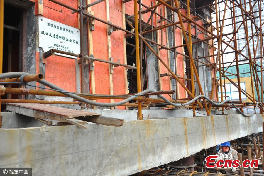 A historic building listed as a cultural relic under government protection is moved as a whole unit in Wuhan City, the capital of Central China’s Hubei Province, March 9, 2016. The three-storeyed, 100-year-old building was first raised 1.4 meters off the ground and then supported by scaffolding in order to move it for 90 meters on six reinforced-concrete tracks. The site is being cleared for a commercial development, local media reported. (Photo/CFP)