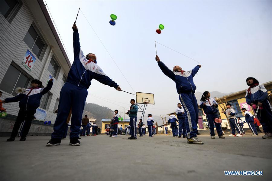 Pupils of Kuaihuolin Primary School exercise with diabolos in Xinglong County of Chengde City, north China\'s Hebei Province, March 16, 2016. Students in Xinglong County learn traditional Chinese martial art, diabolo exercising and Hulusi performance during their spare time. (Photo: Xinhua/Wang Liqun)