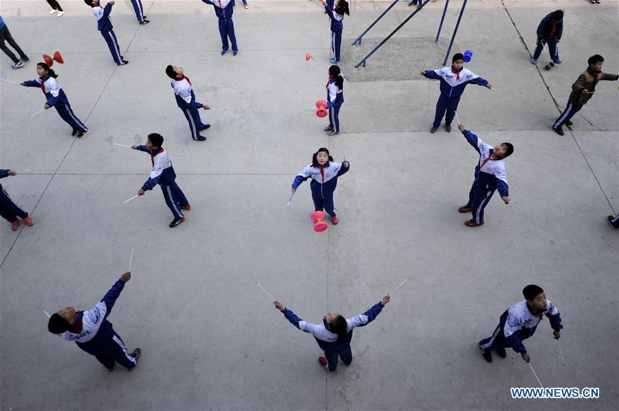 Pupils of Foyelai Primary School exercise with diabolos in Xinglong County of Chengde City, north China\'s Hebei Province, March 16, 2016. Students in Xinglong County learn traditional Chinese martial art, diabolo exercising and Hulusi performance during their spare time. (Photo: Xinhua/Wang Liqun)