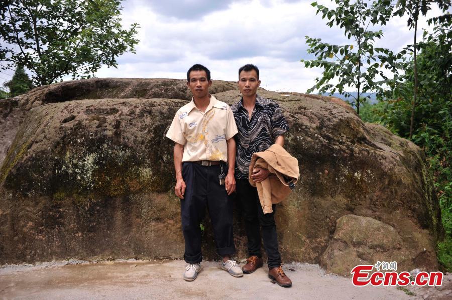 Twin brothers pose for a photo in Qingyan Village, Jiangjin District, Southwest China’s Chongqing Municipality, July 5, 2016. The village of 367 households has 39 pairs of twins, with the oldest 89 years old. (Photo: China News Service/Chen Chao)