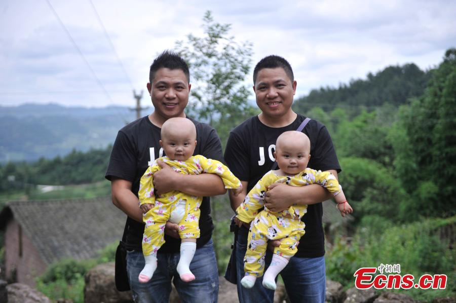 Twin brothers pose for a photo in Qingyan Village, Jiangjin District, Southwest China’s Chongqing Municipality, July 5, 2016. The village of 367 households has 39 pairs of twins, with the oldest 89 years old. (Photo: China News Service/Chen Chao)