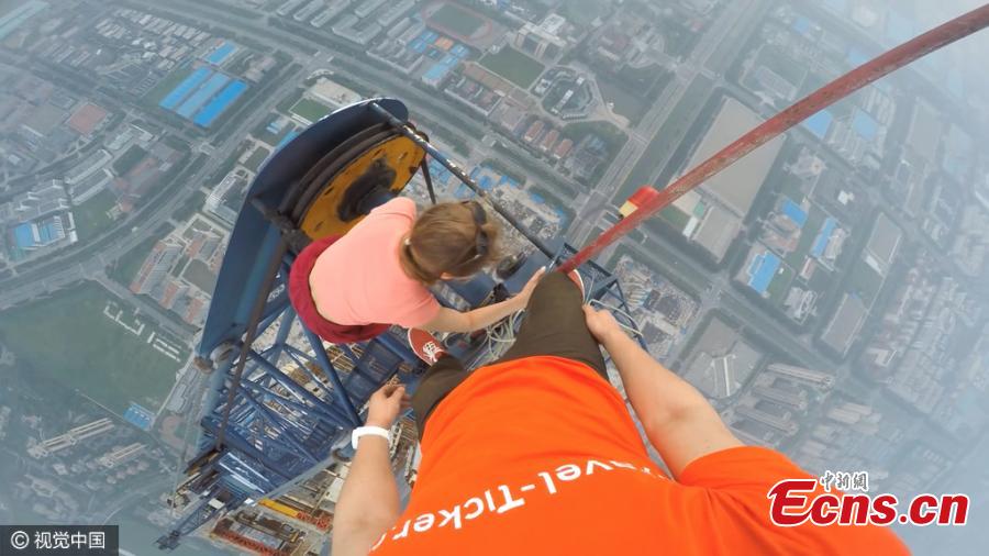 Two Russian climbers, Ivan Kuznetsov, 22, and Angela Nikolau, 23, scale the top of the 640-meter-tall Goldin Finance 117, which is under construction in North China’s Tianjin Municipality, Aug. 23, 2016. The Russian couple started their climb at 3am and used both cameras and a drone to record the process. The skyscraper is expected to be the tallest building in China after construction is complete. (Photo/CFP)