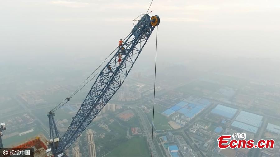 Two Russian climbers, Ivan Kuznetsov, 22, and Angela Nikolau, 23, scale the top of the 640-meter-tall Goldin Finance 117, which is under construction in North China’s Tianjin Municipality, Aug. 23, 2016. The Russian couple started their climb at 3am and used both cameras and a drone to record the process. The skyscraper is expected to be the tallest building in China after construction is complete. (Photo/CFP)