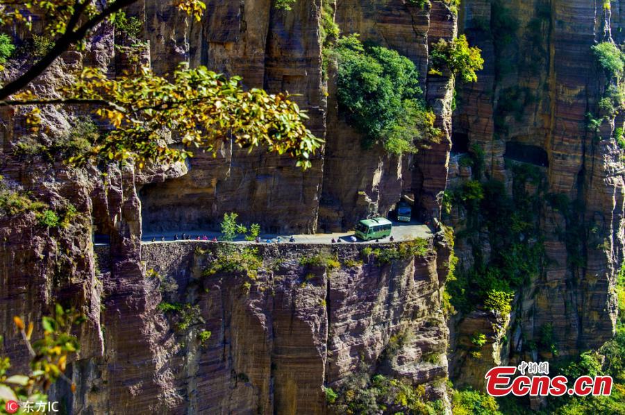 Guoliang village in Huixian County, Henan Province perches on a mountaintop 1,700 meters above sea level and is besieged by cliffs on three sides. In 1972, to find a safe way in and out of the village, local people chiseled through the stone cliffs and created a 5-meter-high and 4-meter-wide passage, using their hands and bamboo baskets to remove the stones. The 1,300-meter-long passage took the villagers five years to complete. Before the passage, stairs chiseled out along the almost vertical cliff, nicknamed \