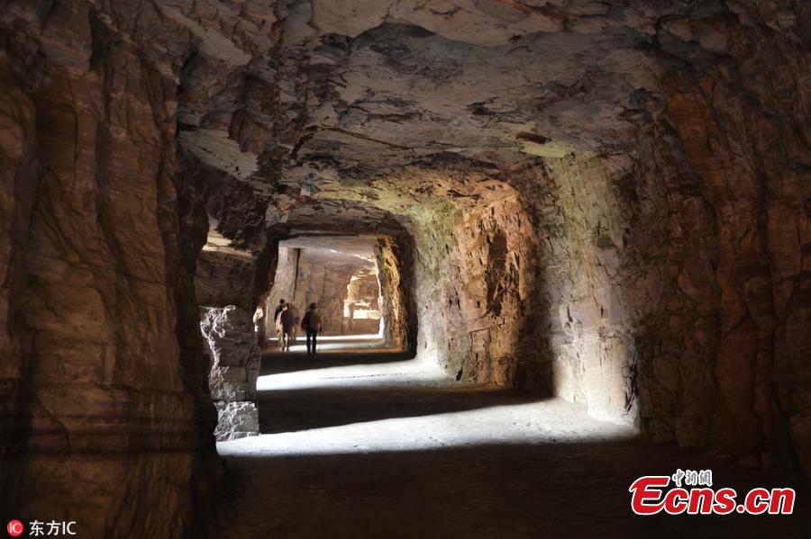 Guoliang village in Huixian County, Henan Province perches on a mountaintop 1,700 meters above sea level and is besieged by cliffs on three sides. In 1972, to find a safe way in and out of the village, local people chiseled through the stone cliffs and created a 5-meter-high and 4-meter-wide passage, using their hands and bamboo baskets to remove the stones. The 1,300-meter-long passage took the villagers five years to complete. Before the passage, stairs chiseled out along the almost vertical cliff, nicknamed \
