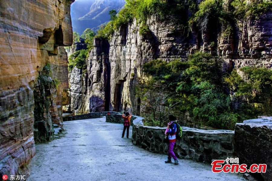 Guoliang village in Huixian County, Henan Province perches on a mountaintop 1,700 meters above sea level and is besieged by cliffs on three sides. In 1972, to find a safe way in and out of the village, local people chiseled through the stone cliffs and created a 5-meter-high and 4-meter-wide passage, using their hands and bamboo baskets to remove the stones. The 1,300-meter-long passage took the villagers five years to complete. Before the passage, stairs chiseled out along the almost vertical cliff, nicknamed \