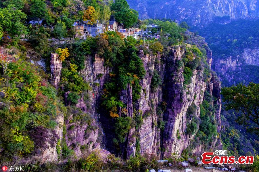 Guoliang village in Huixian County, Henan Province perches on a mountaintop 1,700 meters above sea level and is besieged by cliffs on three sides. In 1972, to find a safe way in and out of the village, local people chiseled through the stone cliffs and created a 5-meter-high and 4-meter-wide passage, using their hands and bamboo baskets to remove the stones. The 1,300-meter-long passage took the villagers five years to complete. Before the passage, stairs chiseled out along the almost vertical cliff, nicknamed \