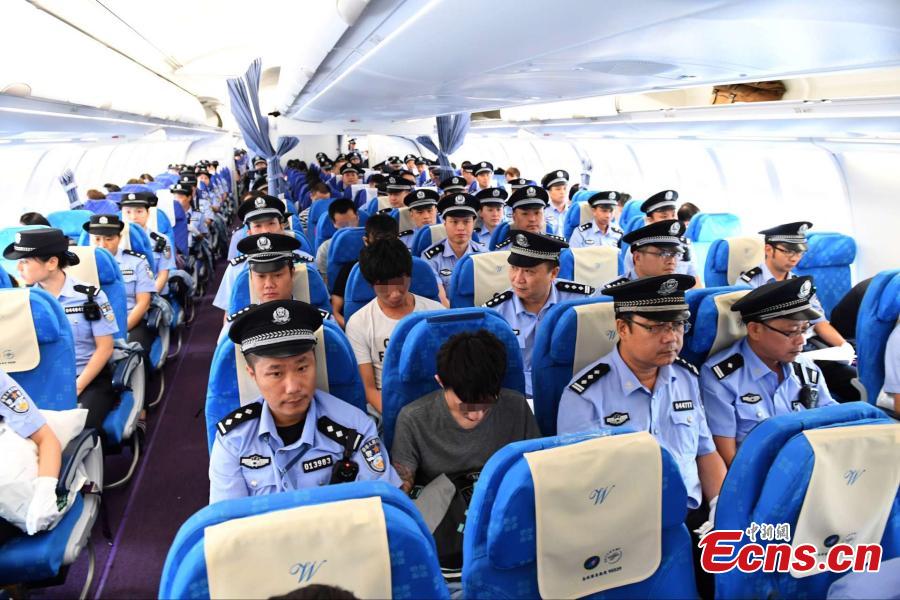 Telecom fraud suspects escorted by Chinese police sit in a charted plane at Baiyun International Airport in Guangzhou City,  capital of South China’s Guangdong Province, Sept. 2, 2016. Armenian police deported 129 Chinese telecom fraud suspects, including 78 from Taiwan, to the Chinese mainland. Investigation found that the syndicate based in Armenia had been falsely representing themselves as law enforcement officers to extort money from people on the Chinese mainland through telephone calls. They were found to have cheated people in about 50 cases worth more than 7 million yuan ($1.2 million). (Photo: China News Service/Jing Guomin)