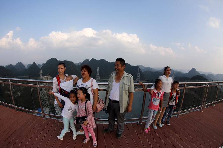 Visitors pose for photo on the viewing platform of \
